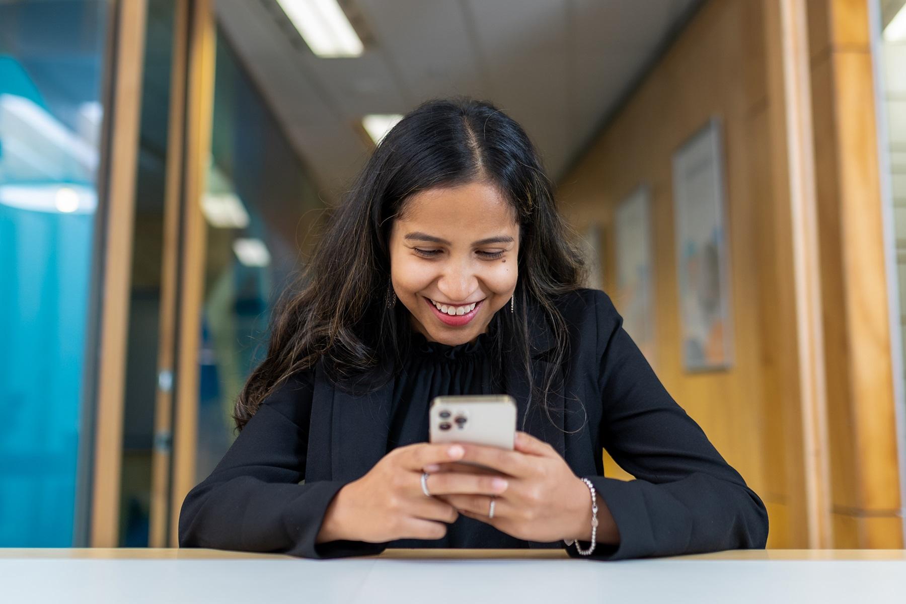 Photo of a woman texting on her smart phone.