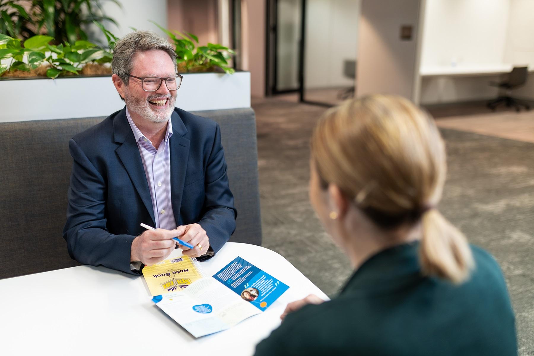 Photo of a male SBDC business adviser meeting with a client.