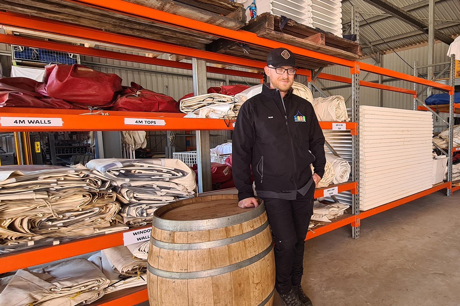 Photo of Sean Thompson, owner of Geraldton Party and Event Hire, standing in his warehouse.