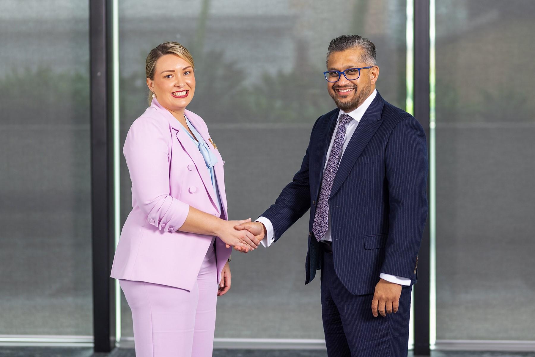 SBDC Board Chair Sharni Foulkes shaking hands with Small Business Commissioner and SBDC CEO Saj Abdoolakhan.