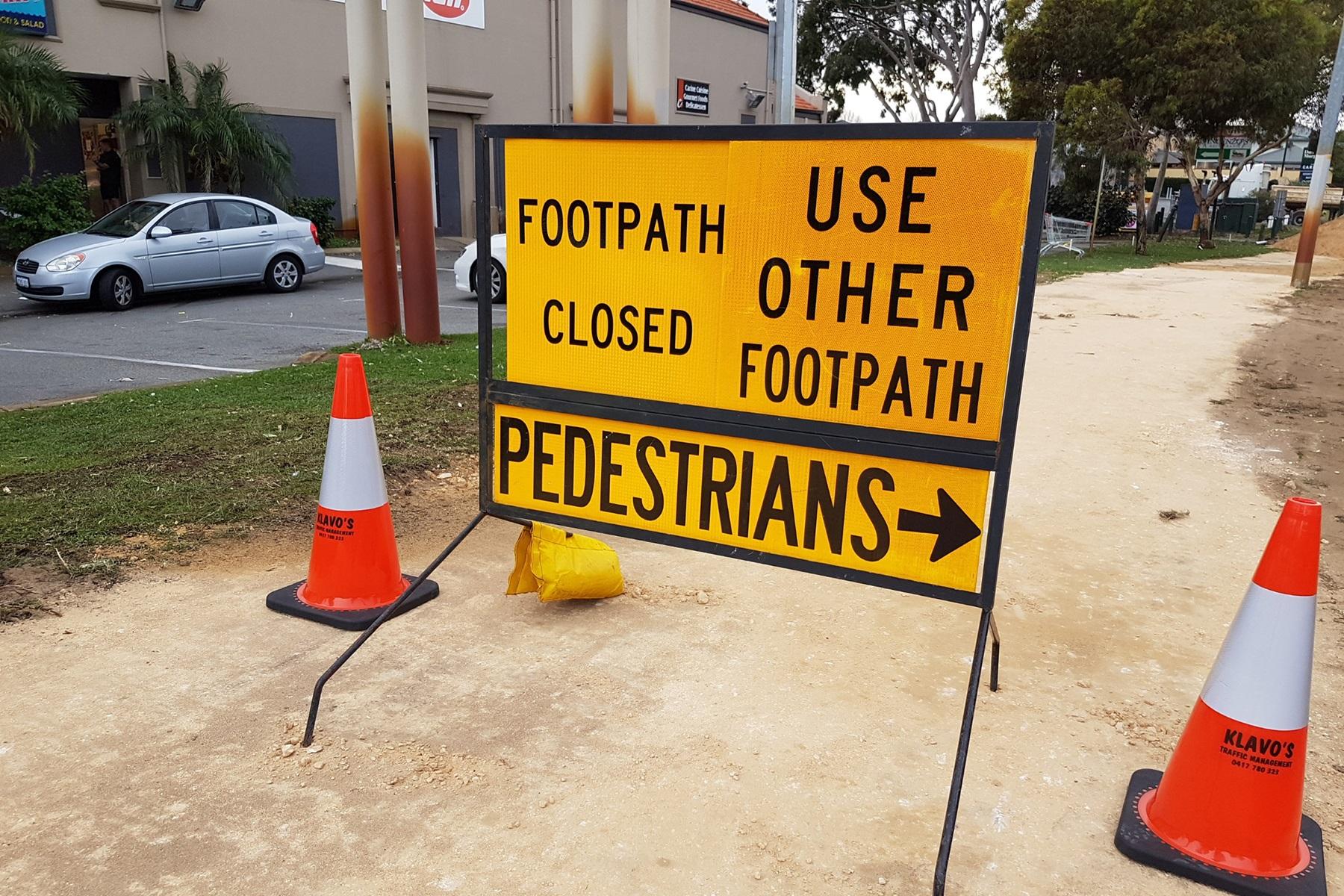 Photo of a construction sign with says 'Footpath closed, use other footpath'.