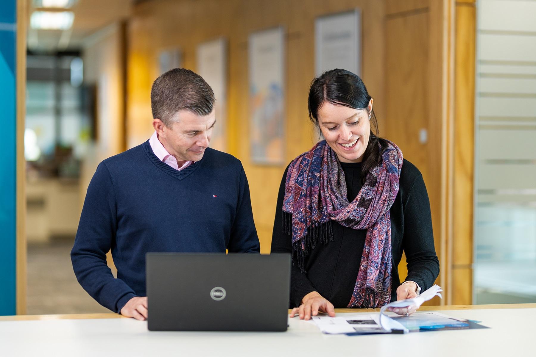 Photo of a man and woman reviewing documentation.