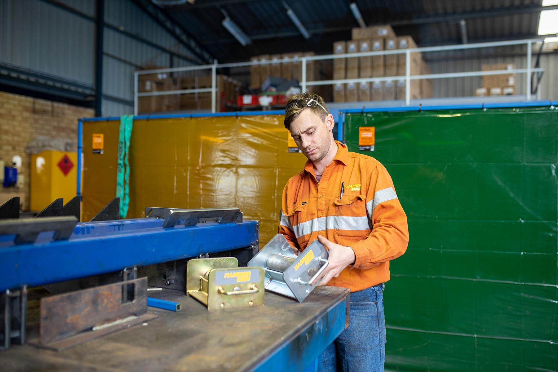 Photo of a man working in a metal fabrication plant.