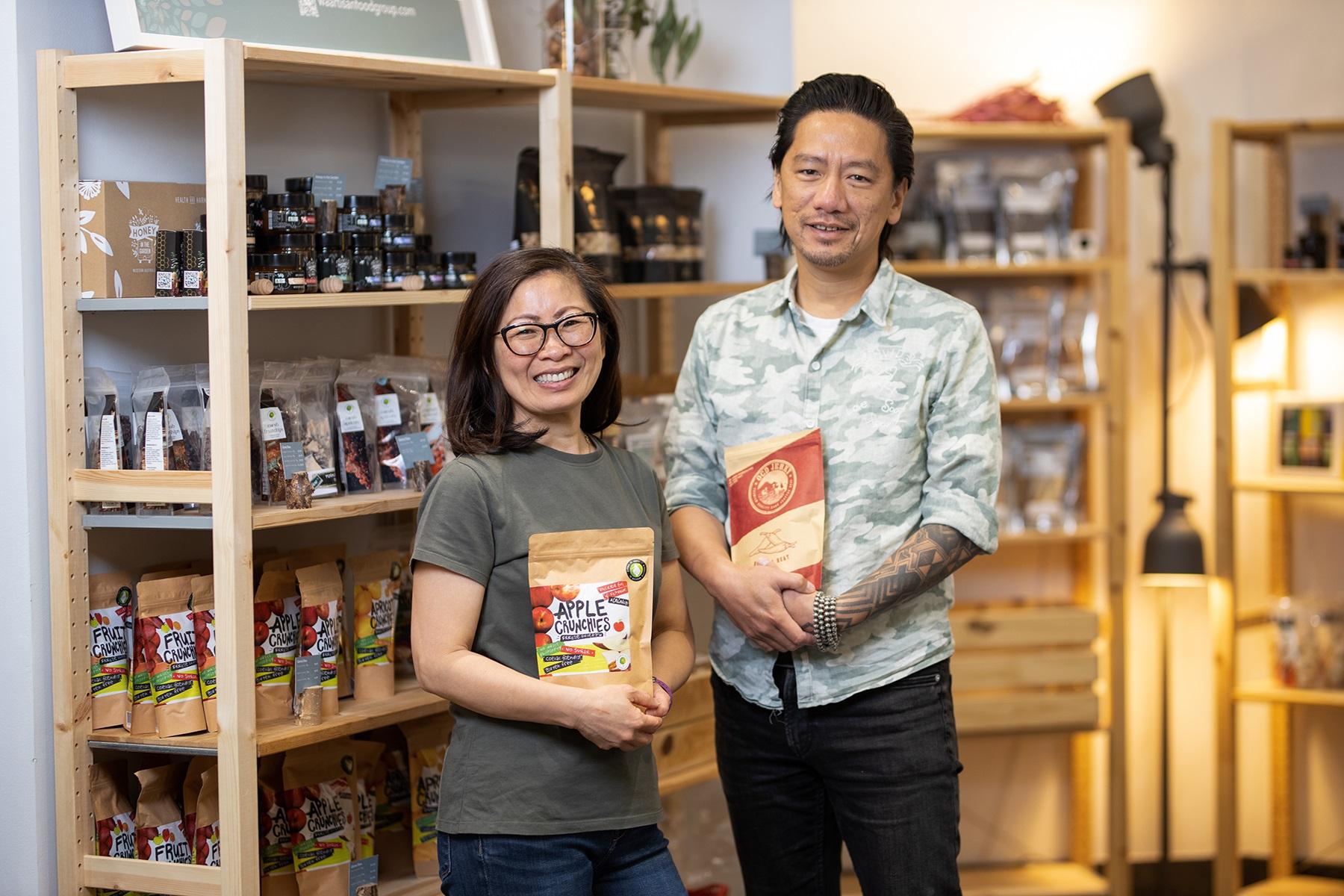 A photo of a man and woman standing in their health food store.