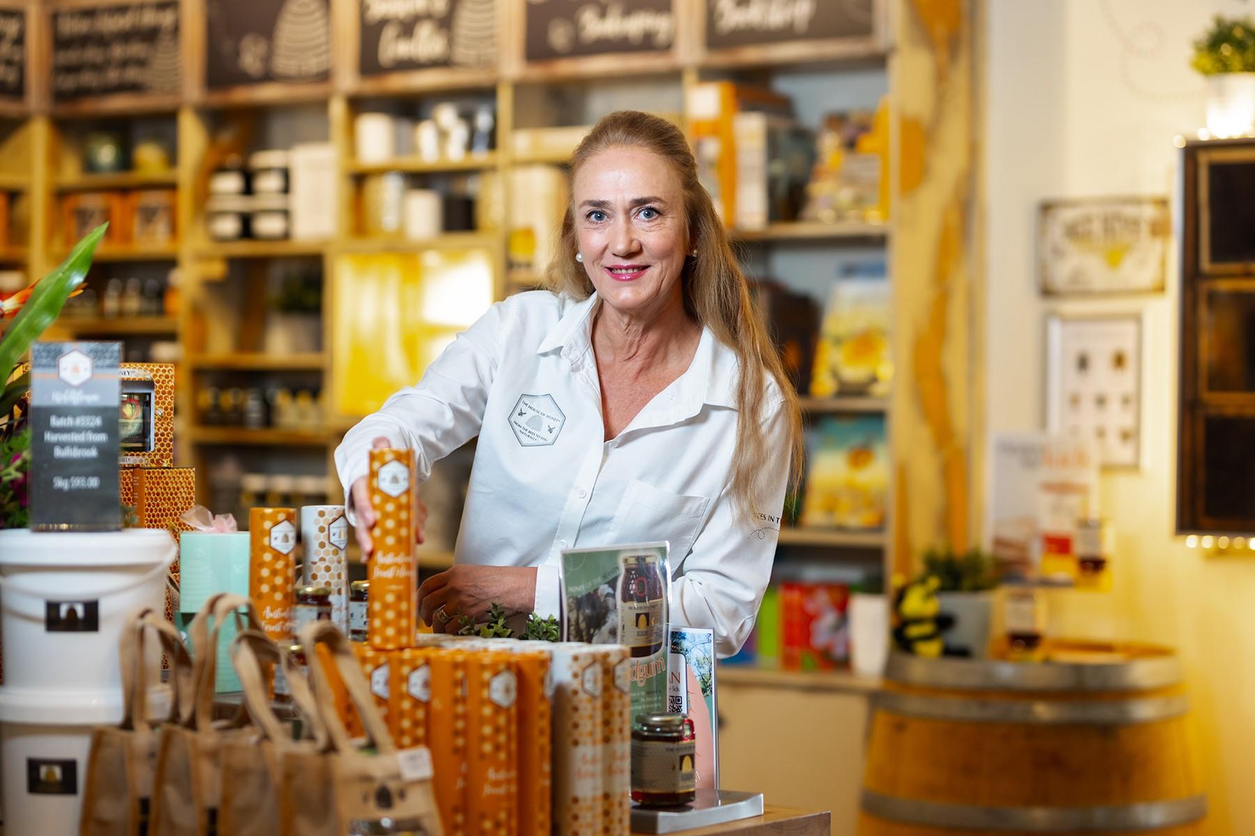 Photo of Kim Phillips, co-worker of The House of Honey. She is standing in her retail store.