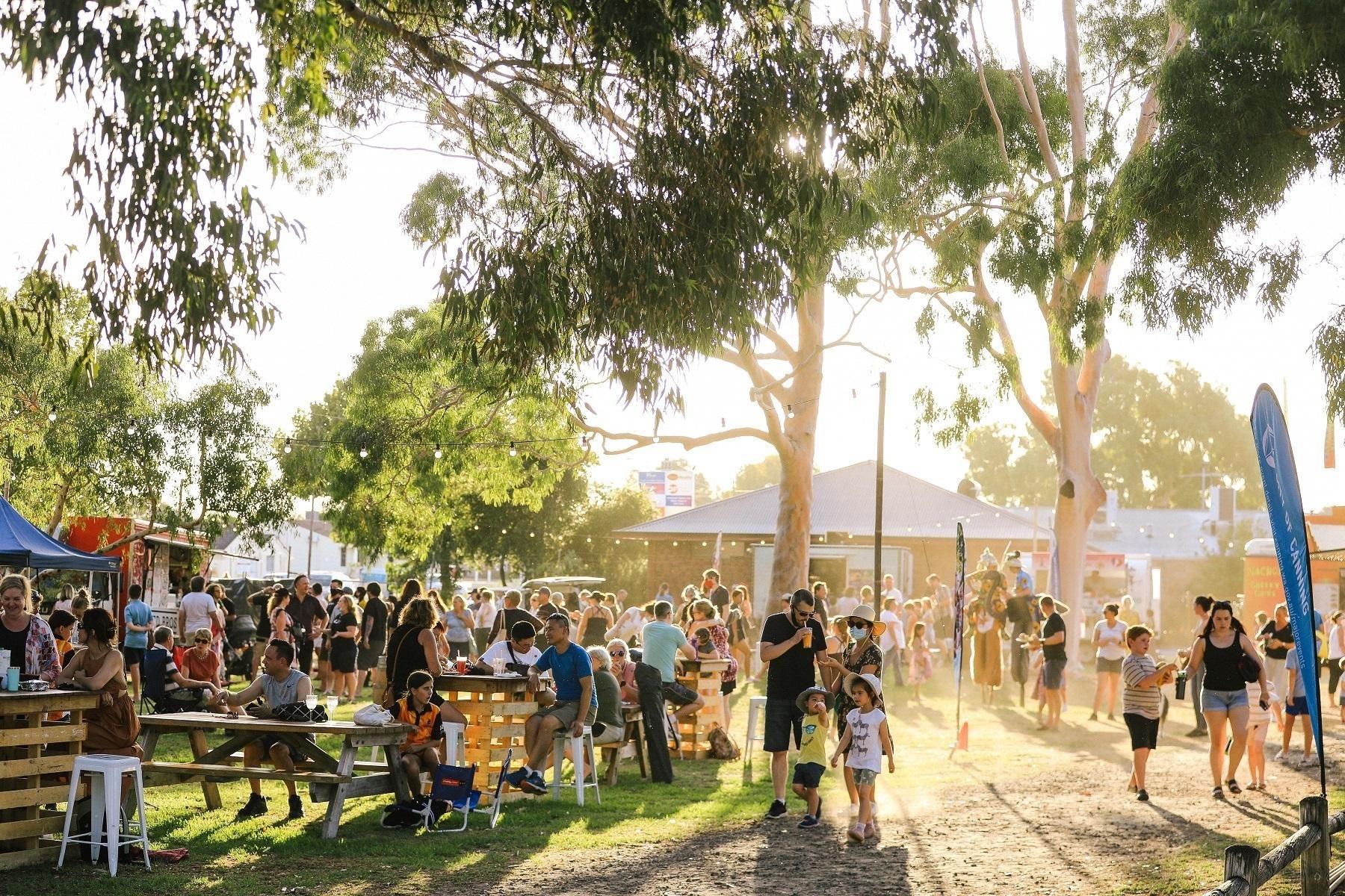 Photo of the City of Canning Midweek Eats event featuring food trucks. Image shows local residents taking part in the event.
